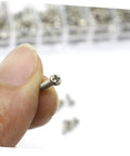 Close-up of a tiny screw from the Miniature Electronics Screw Kit For Repairs With Assorted Tiny Screws For Glasses, Watches, Laptops.