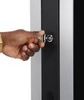 Person unlocking Heavy Duty 43 Inch Dual Sided Touchscreen Kiosk with a key for secure access.