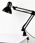 Rock Solid Desk Lamp Mount with Swing Arm Clamp Holder Fits Anything Under 12 Mm Tube for DIY Table Lamps and LED Fixtures, mounted on a white desk.