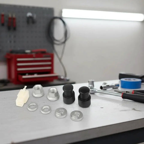 Must Have M12 EBike Hub Motor Axle Nut Kit with front lock nut, washer, and protective cover for 12mm shafts on workbench