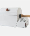 Rock Solid Home Coffee Roaster Featuring Quartz Heating Tube Adjustable Temperature Settings For Fresh Morning Beans Stainless Steel Electric Roasting Machine Smooth Operator Kitchen Must Have side view with wooden handle.