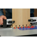 Person using Router Table Dovetail Joinery Jig for smooth, stable, repeatable dovetail cuts on woodworking project on router table.