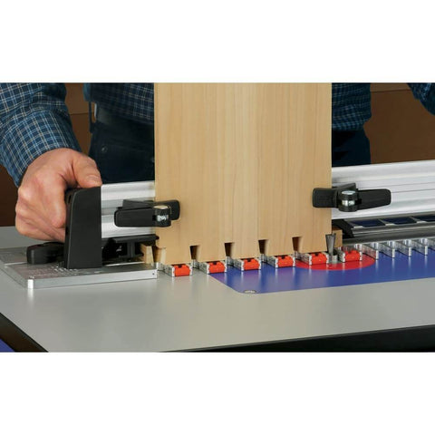 Person using Router Table Dovetail Joinery Jig for smooth, stable, repeatable dovetail cuts on woodworking project on router table.