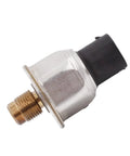 Close-up of brake fluid pressure sensor with brass threaded end and black connector.