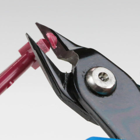 Close-up of All Purpose Model Nipper PN-125 For Plastic Models cutting a plastic rod, showcasing precision and sharpness.