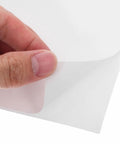 Close-up of 160 Sheets 4x6 Inch Waterproof Synthetic Paper Shipping Labels With Ample Writing Space peeled by hand