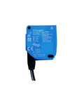 WTT2L-B2561 sensor with blue casing and connected black cable, visible branding and specifications on body, isolated on white background.