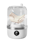 Compact Portable Washing Machine For Travelers And Students Slick Laundry Appliance washing underwear in clear container with water.