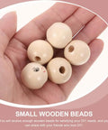 Hand holding 14mm Round Wooden Smile Face Beads Set, 50 Pieces Doll Head Wood Beads, Loose Beads for DIY crafts