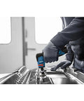 Compact 12 Volt Max Brushless Right Angle Die Grinder With Variable Speed Trigger And Five Speed Options in use on metal surface.