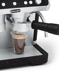 Close-up of Casdon De'Longhi toy barista coffee machine in silver/black with portafilter over a cup