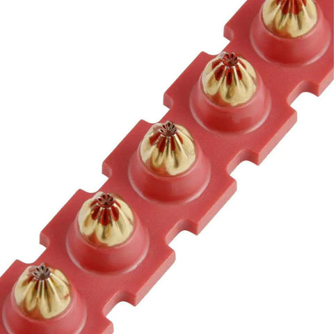 Close-up of Red Shot.27 Powder Actuated Fastener Cartridges Set Of Six For Beefed-Up Construction Jobs on a red strip