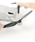Premium Carbon Fiber Propeller Blades Compatible with Mini 3 Pro and Mini 4 Pro shown being installed with screwdriver.