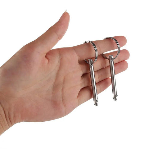Hand holding Two Pack Quick Release Pin For Boats And Bimini Tops, 3 Sixteenth Inch Diameter, Overall Length Two Inches, Full 316 Stainless Steel.