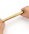Hands holding Two Pack 1 Inch Diameter Brass Rod Lathe Bar 12 Inch Length Brass Bar Stock Premium Solid Brass Rods For DIY Crafts Model Planes And Ship Models Ideal For Hobbyists And Makers