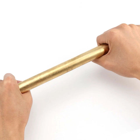 Hands holding Two Pack 1 Inch Diameter Brass Rod Lathe Bar 12 Inch Length Brass Bar Stock Premium Solid Brass Rods For DIY Crafts Model Planes And Ship Models Ideal For Hobbyists And Makers