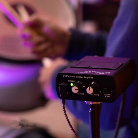 S1 Personal In-Ear Monitor Headphone Amplifier for Drummers, Keyboardists, Guitarists, shows volume controls, on stage.