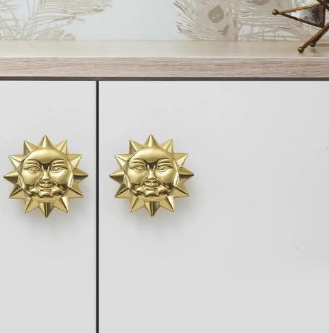 Solid brass antique finish Sun Moon Cabinet Knobs Set installed on white cabinet doors, showing celestial design and rust resistance.