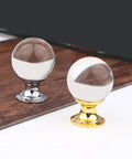Crystal Glass Cabinet Knobs Set 4 Pack With Gold Finish Single Hole Drawer Pulls For Kitchen Cabinets And Furniture European Style Sparkling Crystal Door Handles Glam Up Your Cabinets With Sleek Gold Shine featuring two round knobs, one with gold and one with silver base, on wood surface.