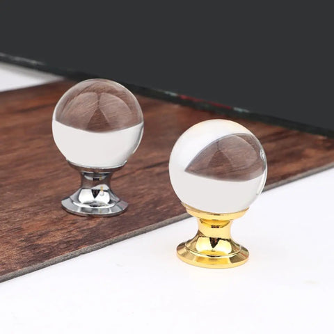 Crystal Glass Cabinet Knobs Set 4 Pack With Gold Finish Single Hole Drawer Pulls For Kitchen Cabinets And Furniture European Style Sparkling Crystal Door Handles Glam Up Your Cabinets With Sleek Gold Shine featuring two round knobs, one with gold and one with silver base, on wood surface.