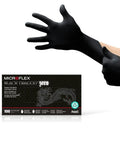 Person putting on Built Different Black Nitrile Work Gloves With Textured Fingertips And Powder Free Comfort For Kickass Grip During Auto Repair And Industrial Demands Box Of One Hundred.