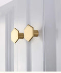 10 Pack 1.3 Inch Gold Cabinet Knobs Solid Brass Hexagon Drawer Pulls Brushed Brass Hardware for Kitchen Cabinets Drawers and Furniture Modern Update Stylish Upgrade For Any Decor shown on white door