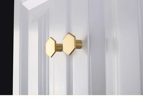 10 Pack 1.3 Inch Gold Cabinet Knobs Solid Brass Hexagon Drawer Pulls Brushed Brass Hardware for Kitchen Cabinets Drawers and Furniture Modern Update Stylish Upgrade For Any Decor shown on white door