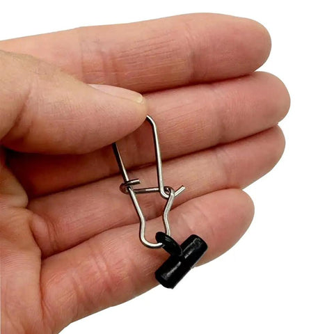 Hand holding stainless steel snap and ABS plastic sinker slide from Sinker Sliders 50 Pack With Six Pound Duo Lock Snap For Fishing Rigs.