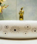 Slick Ceramic Oval Vessel Sink For Modern Bathroom Counters Smooth Glazed Finish with floral design and 12 liter capacity.
