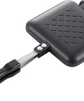 Chomp Out Cheesy, Crispy Panini Wonders With This Aluminum Flip Grill showing lightweight black sandwich press with long handle.