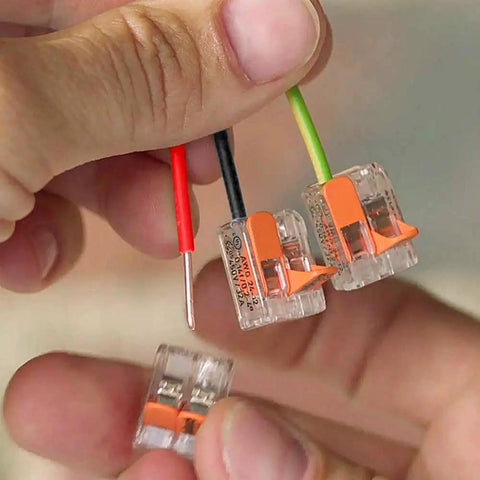 Hands holding Lever Nut Wire Connector Set 221 Series 35pc Compact Splicing Kit with transparent blocks and copper wires.