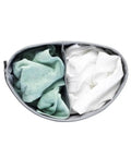 Interior view of Big Ol Two-Section Laundry Hamper With Removable Inner Bags, showing separated green and white towels.