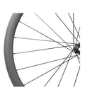 Close-up of 700C Carbon Disc Wheelset 38mm Clincher Road Bike Wheels Centerlock With Sapim Spokes For Slick Aero Ride