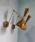 1950 Mid Century Italian Hardwire Brass Wall Sconce Pair Brown Wall Fixture Diabolo Lamp mounted on blue wall.