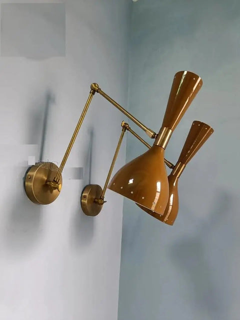 1950 Mid Century Italian Hardwire Brass Wall Sconce Pair Brown Wall Fixture Diabolo Lamp mounted on blue wall.