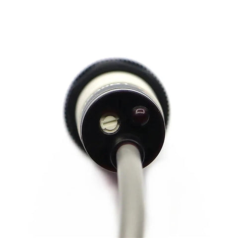 Close-up of ER18-DS30C1 Photoelectric Sensor E3f Electric Switch with wiring, designed for automation jobs in industrial settings.
