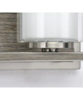 Close-up of Four Light Linear Chandelier In Brushed Nickel With Faux Wood Back Plate And Clear And Etched Glass Shades