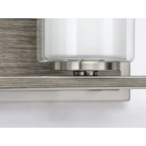 Close-up of Four Light Linear Chandelier In Brushed Nickel With Faux Wood Back Plate And Clear And Etched Glass Shades