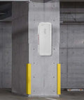 20 Pack White Surface Mount Fire Extinguisher Cabinet with Pull Panel for 5 Lb Extinguisher mounted on concrete wall in parking area.