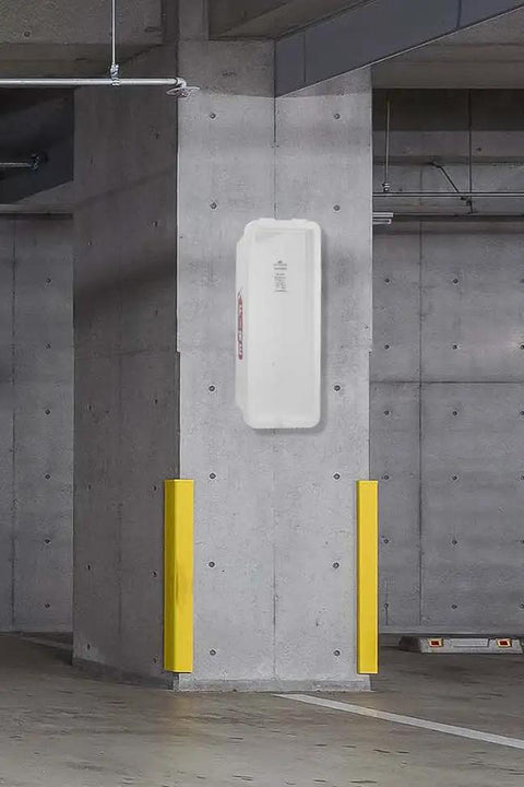 20 Pack White Surface Mount Fire Extinguisher Cabinet with Pull Panel for 5 Lb Extinguisher mounted on concrete wall in parking area.