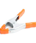 2 Inch Spring Clamp With Handle One Handed Clamping Tool Silver Orange Finish Quick Release Paddle Action for Woodworking and DIY Projects Workhorse Grip Control, close-up view.