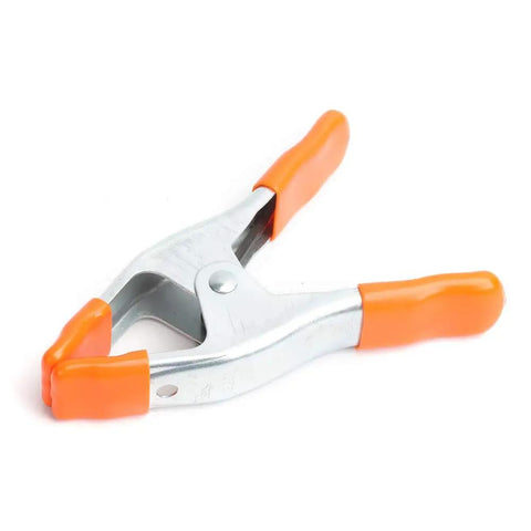 2 Inch Spring Clamp With Handle One Handed Clamping Tool Silver Orange Finish Quick Release Paddle Action for Woodworking and DIY Projects Workhorse Grip Control, close-up view.