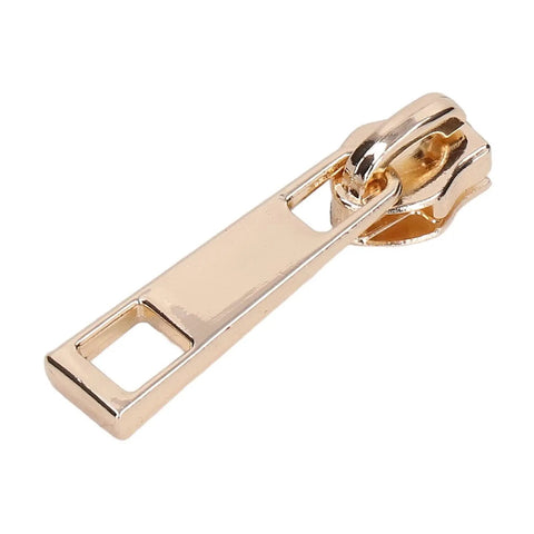 Close-up of a zipper pull from the 5 Piece Zipper Sliders Set For Quick On The Go Fixes Detachable Reusable Zipper Pulls Replacement Kit in Light Gold.