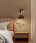 Swing Arm Wall Sconce, Modern Wood Lamp Bedside Reading Bedroom with wood shade and chrome arm beside a bed.