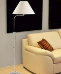Traditional One Light Floor Lamp In Brushed Steel Finish With Pewter Nickel Accents beside cream sofa in living room