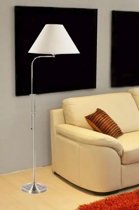 Traditional One Light Floor Lamp In Brushed Steel Finish With Pewter Nickel Accents beside cream sofa in living room