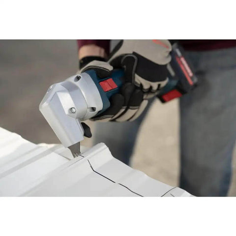 18V 16 Gauge Nibbler with Brushless Motor cutting sheet metal, showing rotating die holder, cordless use visible