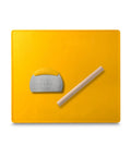 Yellow silicone baking mat with metal scraper and wooden rolling pin.