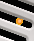 Close-up of Slim SLM70H No Frills Exhaust Bath Fan With Humidity Sensor showing vent design with orange LED indicator light visible.