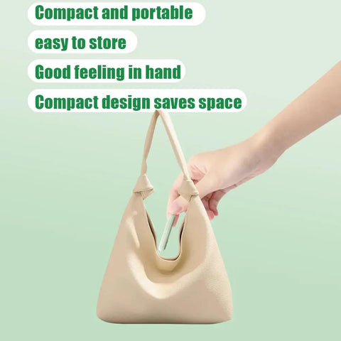 Hand holding Two-In-One Sewing Needle Threader And Seam Ripper, Versatile Tool For Sewing, Quilting inside beige bag